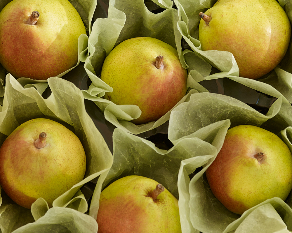 Six pears placed in wrapping paper