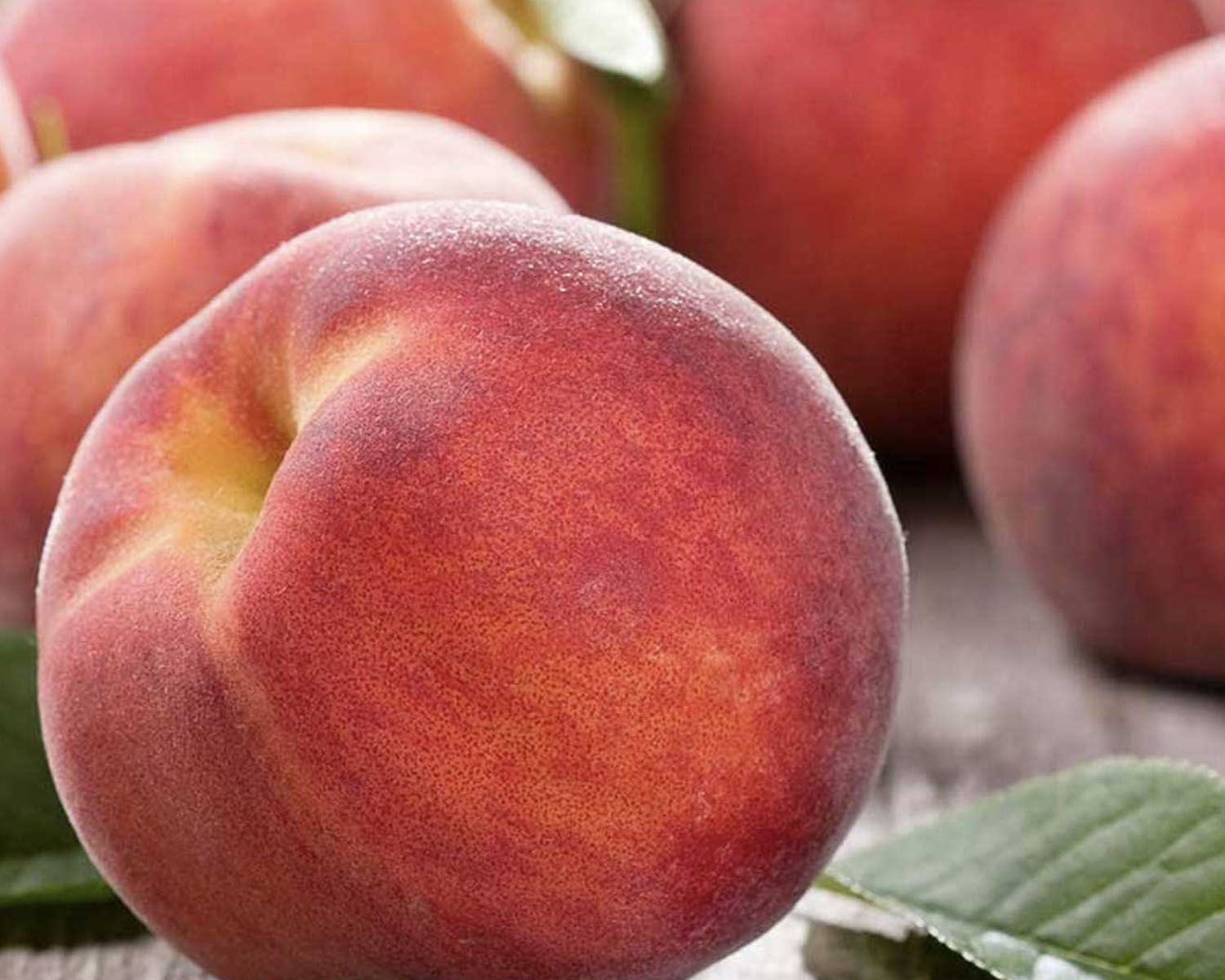 Closeup of whole peaches on a table