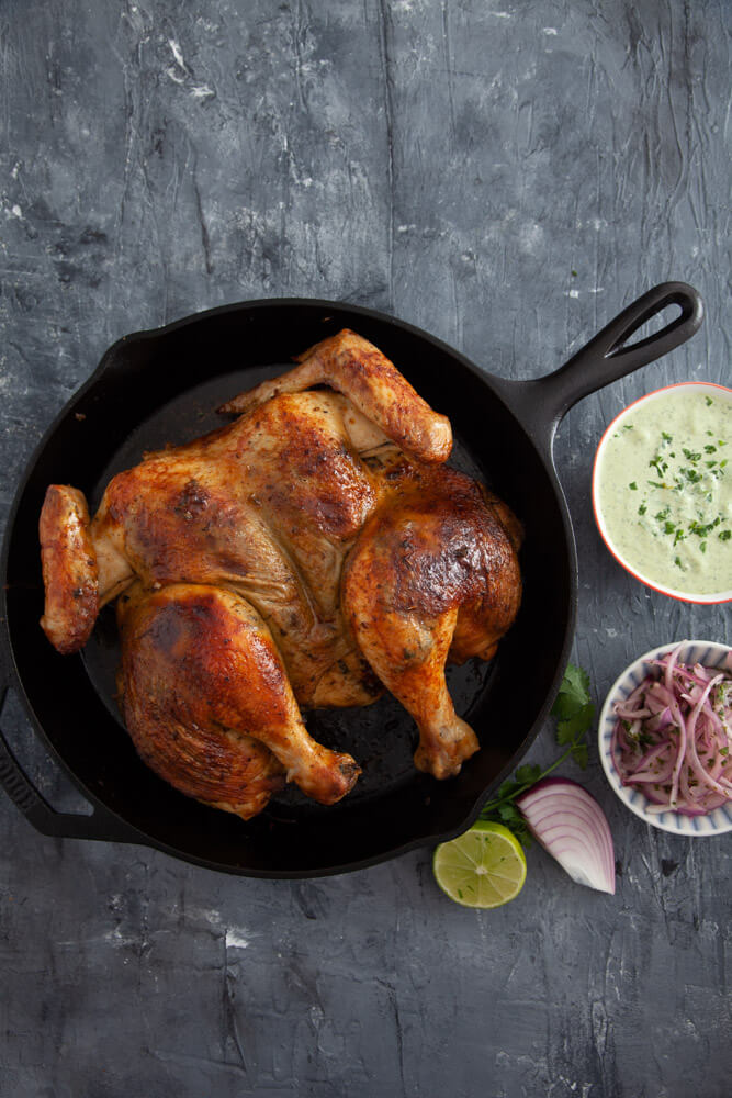 peruvian style chicken with spicy green mayonnaise and pickled onions