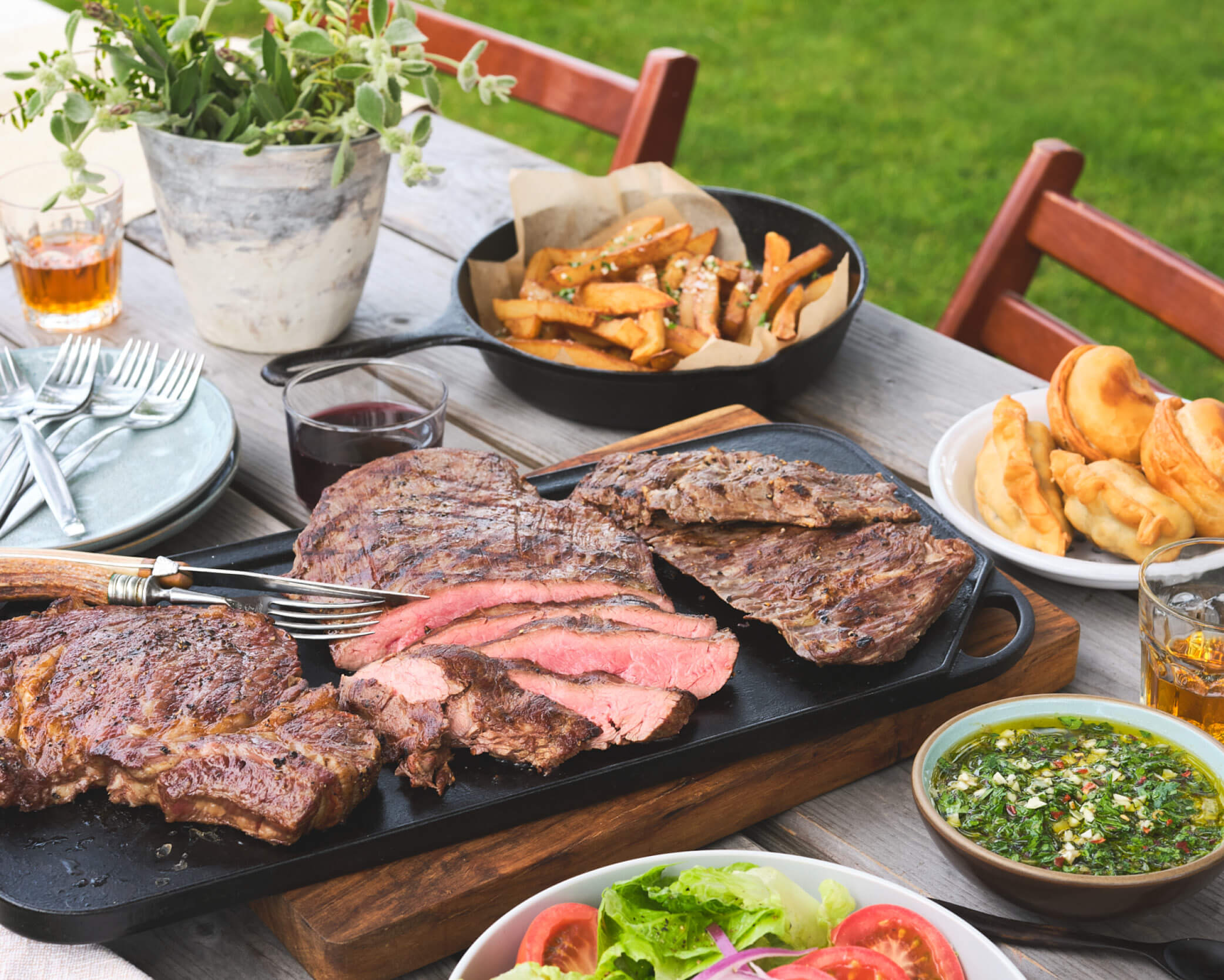 Grilled meats and veggies on picnic table outdoor eating