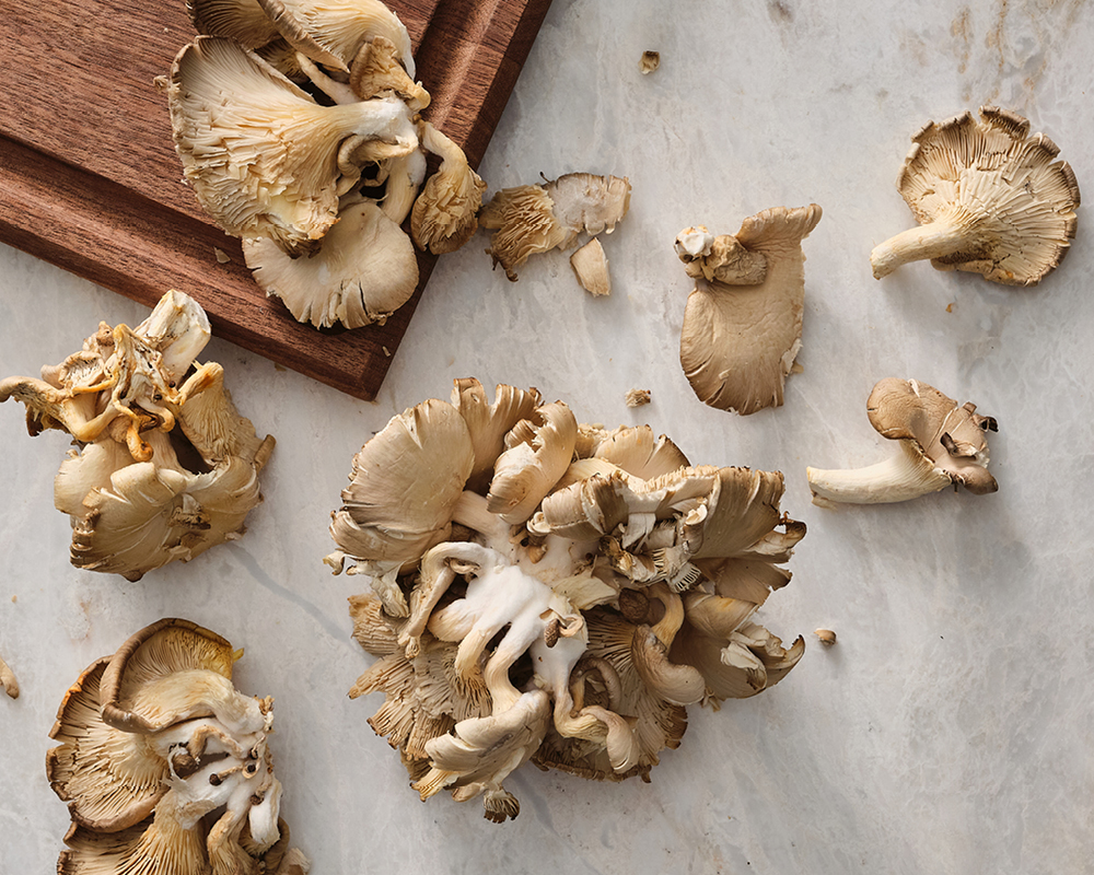 Assortment of Oyster Mushrooms on Marble and Wooden Cutting Board