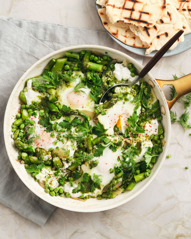 green shakshuka with peas and asparagus