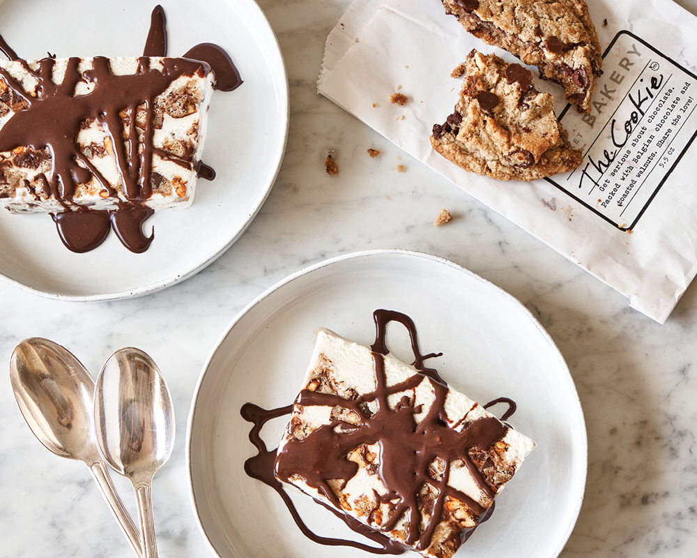 Two ice cream sandwiches, spoons, and the cookie