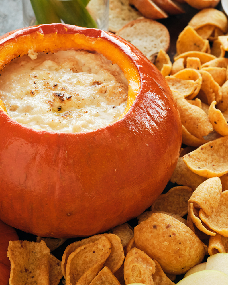 Pumpkin Fondue in Pumpkin surrounded by garnishes
