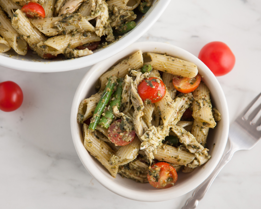 Pesto pasta with chicken, green beans, and tomatoes