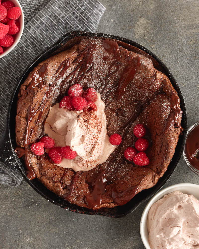 chocolate dutch baby with raspberries and cream