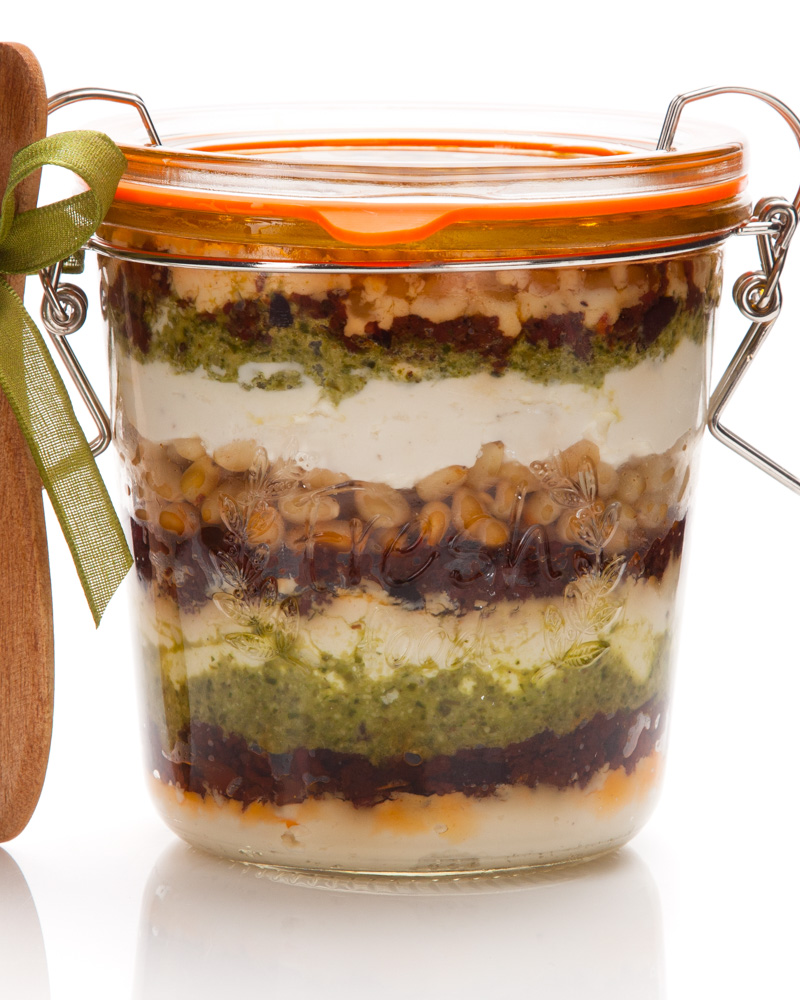 goat cheese spread with pesto, pine nuts, and tapenade