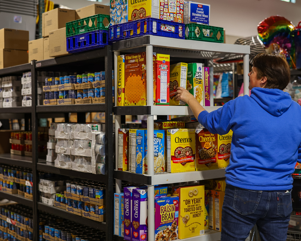 Person stocking non-perishable goods on shelves