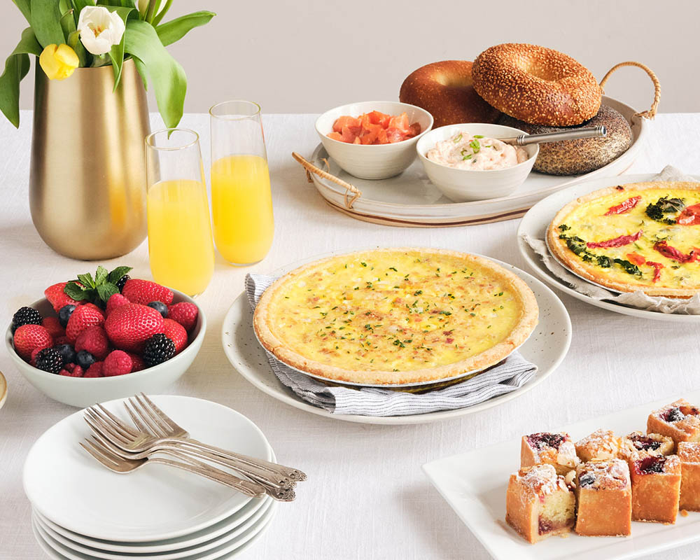 Assortment of Spring Brunch Products Quiche, Cut Fruit, Lox Bagels