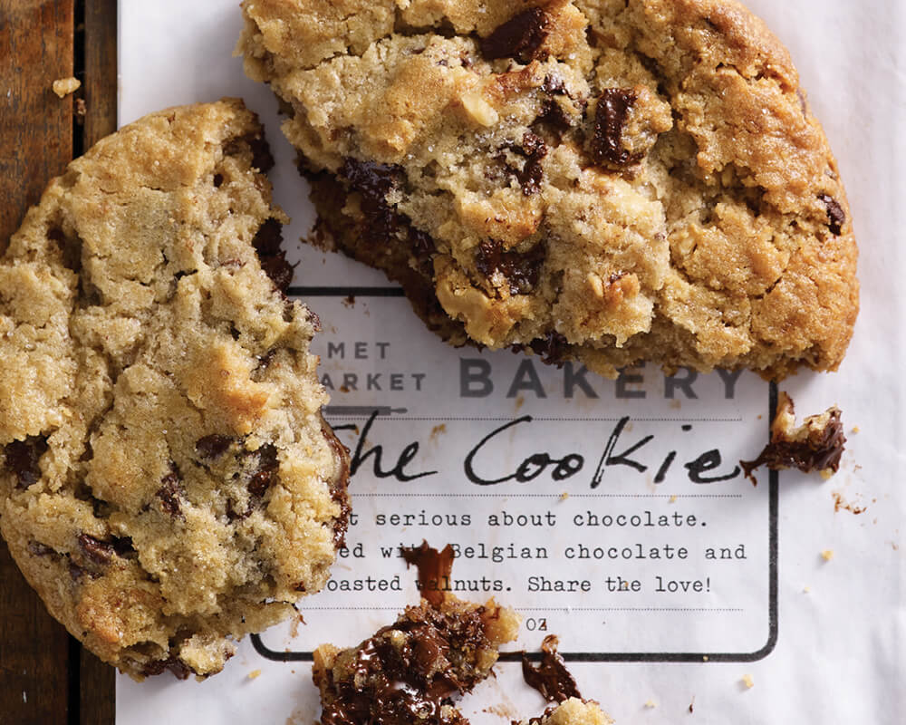 a large chocolate chip cookie broken in three pieces