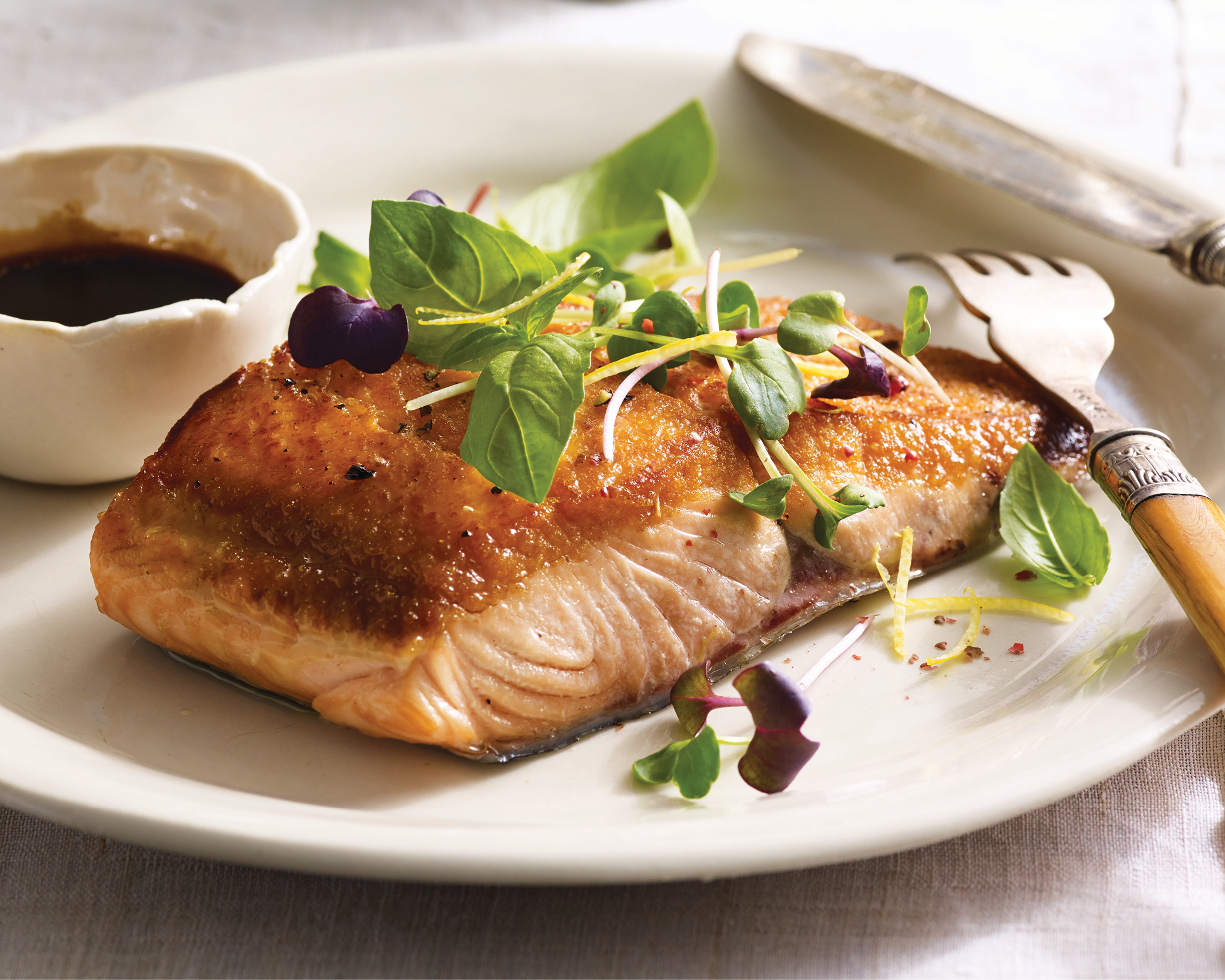 salmon on a plate with microgreens