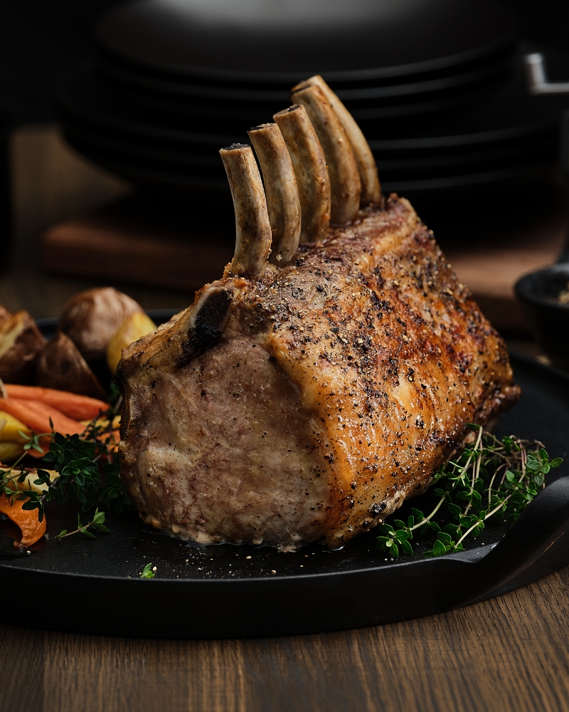 Roasted Pork with Garnishes on Dark Plate