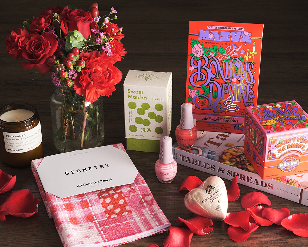 An assortment of Valentine's gifts with rose petals
