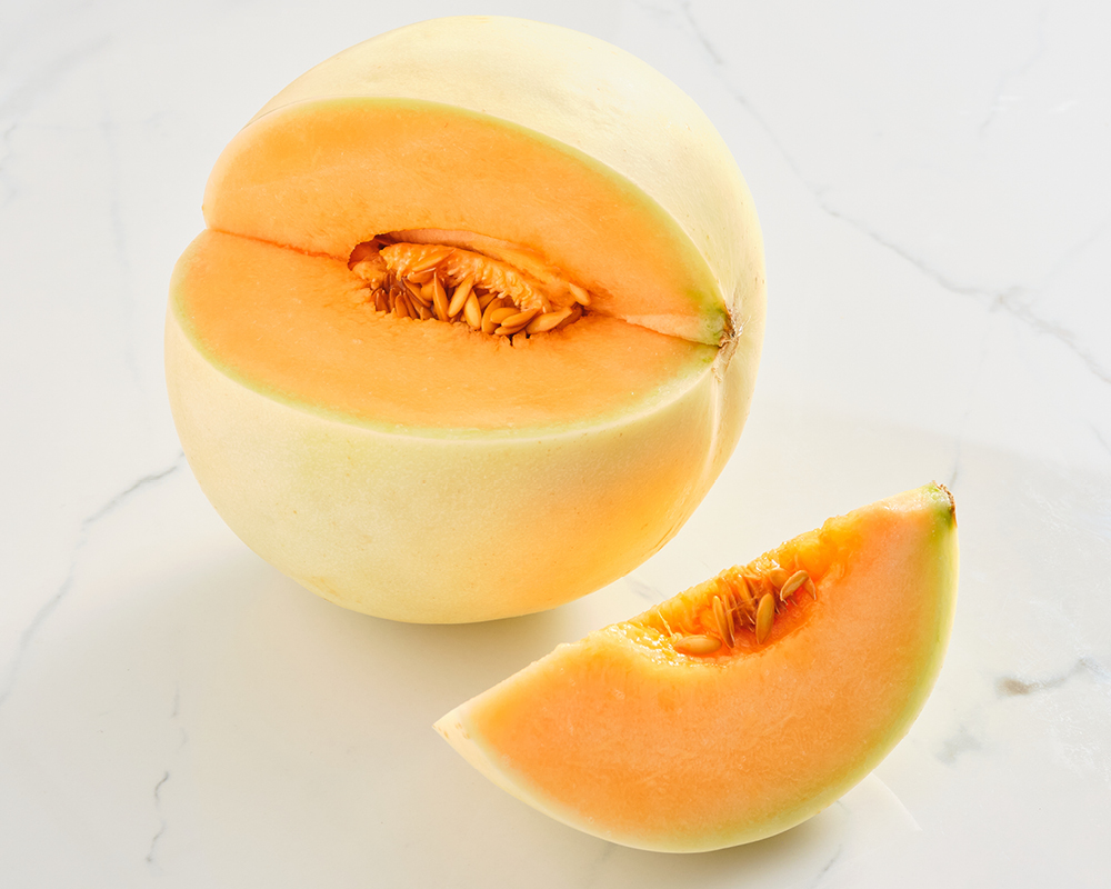 Orange honeydew melon with cut wedge