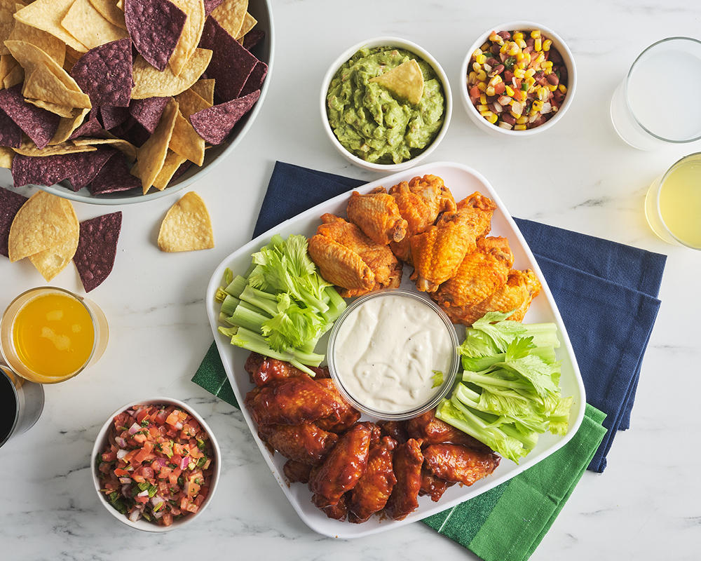 Chicken wing tray, dips, drinks, and chips