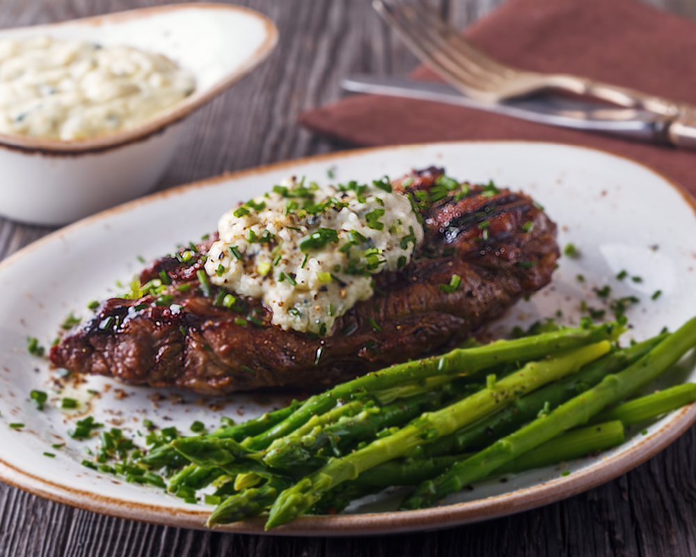 New York beef steak with blue cheese and asparagus